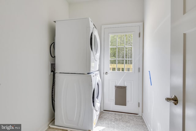 washroom featuring stacked washing maching and dryer