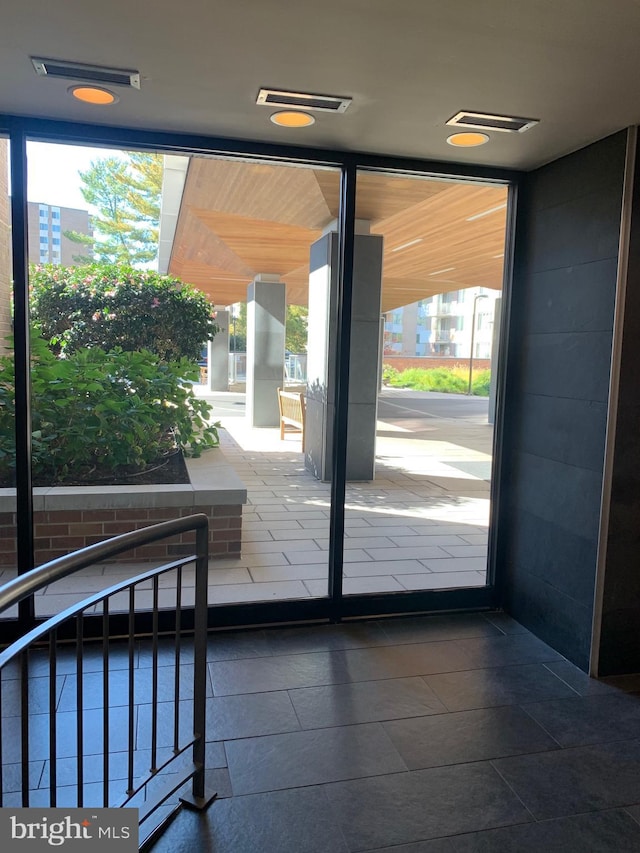 entryway with tile patterned floors and visible vents