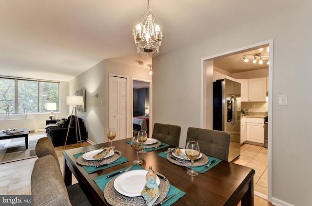 tiled dining space featuring a notable chandelier