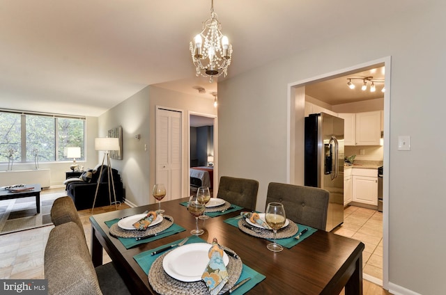 dining room with an inviting chandelier and light tile patterned floors
