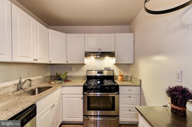 kitchen featuring white cabinetry, stainless steel appliances, under cabinet range hood, and a sink