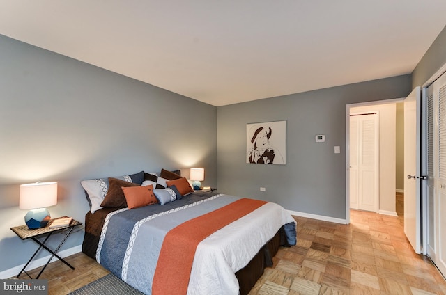 bedroom with a closet and light parquet flooring