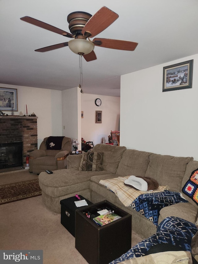 living room featuring a stone fireplace, carpet flooring, and ceiling fan