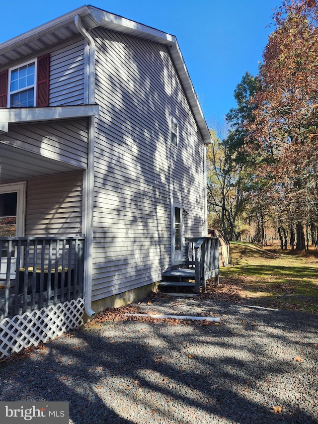 view of side of home featuring a wooden deck