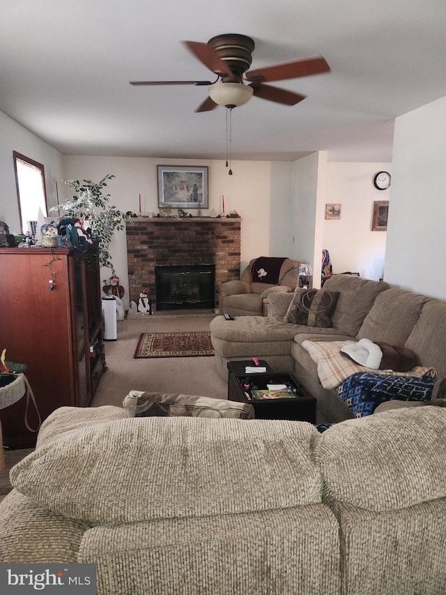 living room with a fireplace and ceiling fan