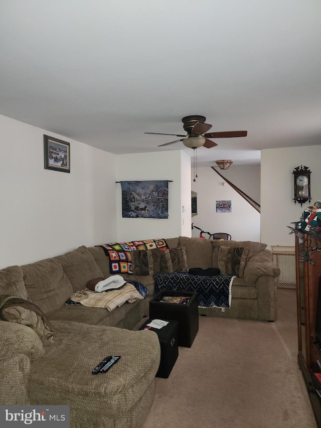 carpeted living room with ceiling fan