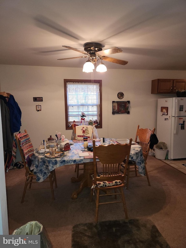 carpeted dining room featuring ceiling fan