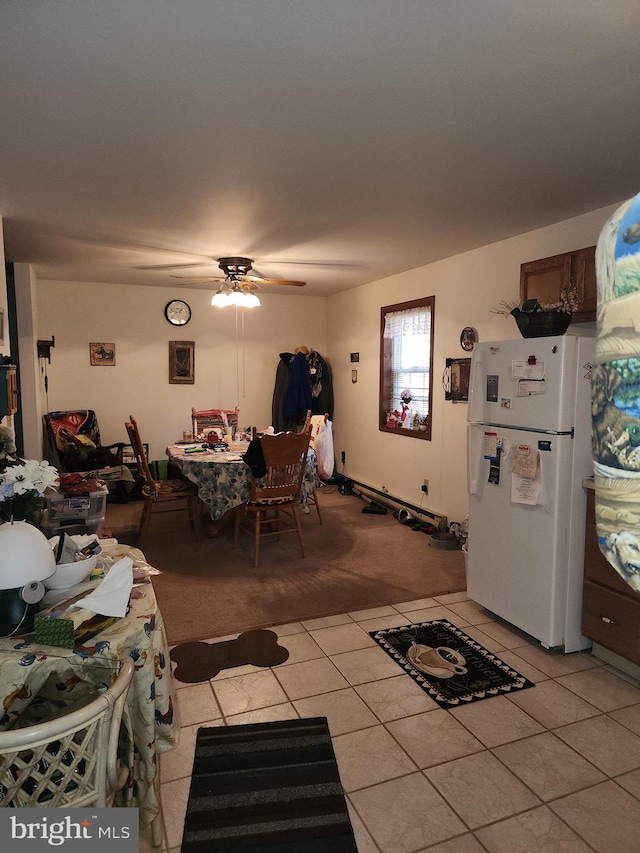 dining space featuring ceiling fan and light carpet