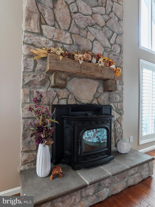 150 Depot Mills Dr, Gerrardstown, WV 25420 - room details featuring baseboards, a wood stove, and wood finished floors