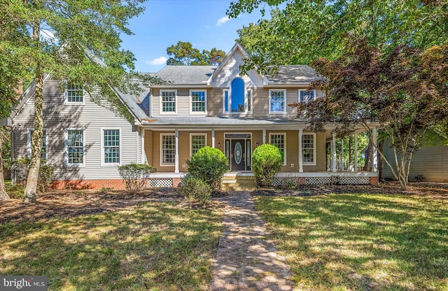 view of front of house with covered porch and a front yard