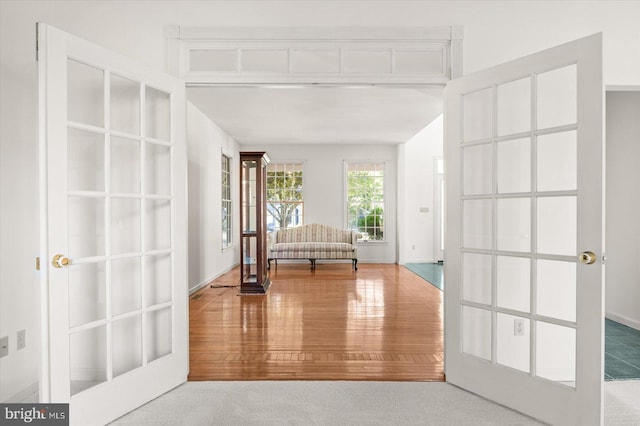 interior space with french doors and hardwood / wood-style flooring