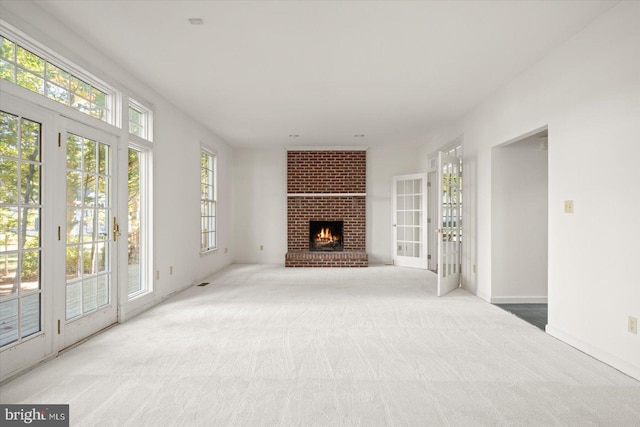 living room with plenty of natural light and light colored carpet