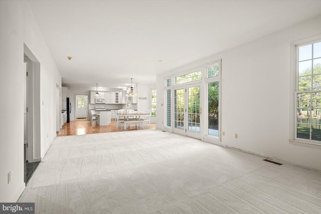 unfurnished living room with light carpet