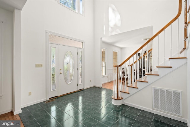 entrance foyer with a high ceiling and plenty of natural light