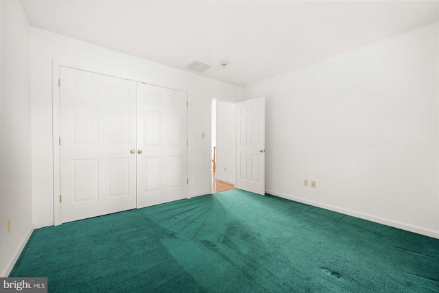 unfurnished bedroom featuring a closet and carpet flooring