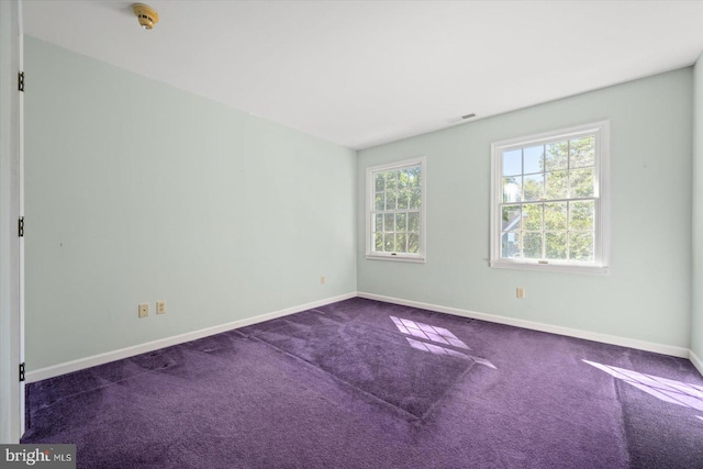 empty room with dark carpet