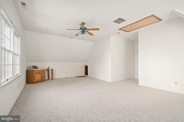 additional living space featuring carpet, vaulted ceiling, and ceiling fan