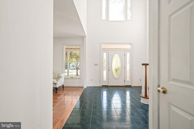 entrance foyer featuring dark tile patterned floors