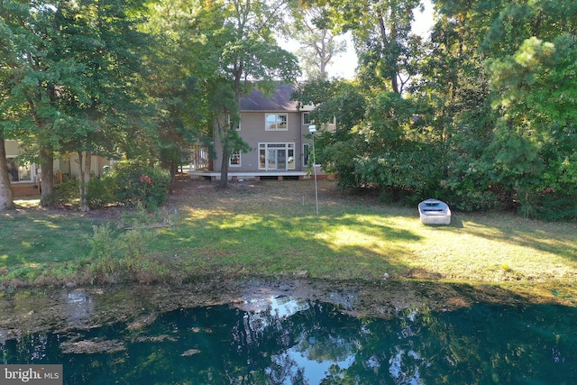 view of yard featuring a deck with water view