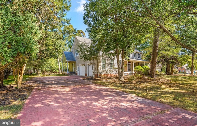 view of front facade with covered porch and a garage