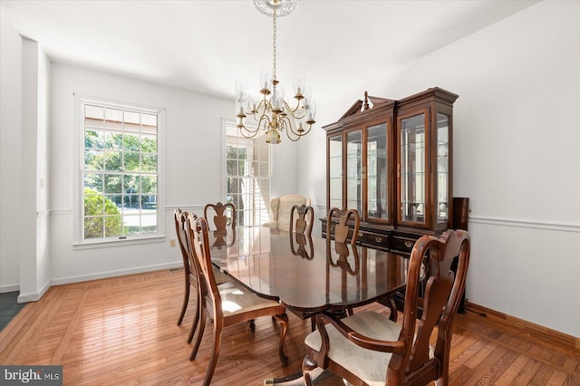 dining space with an inviting chandelier and wood-type flooring