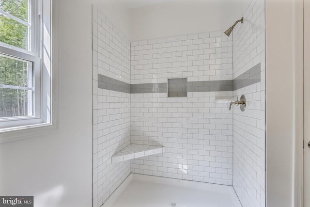 bathroom with a tile shower