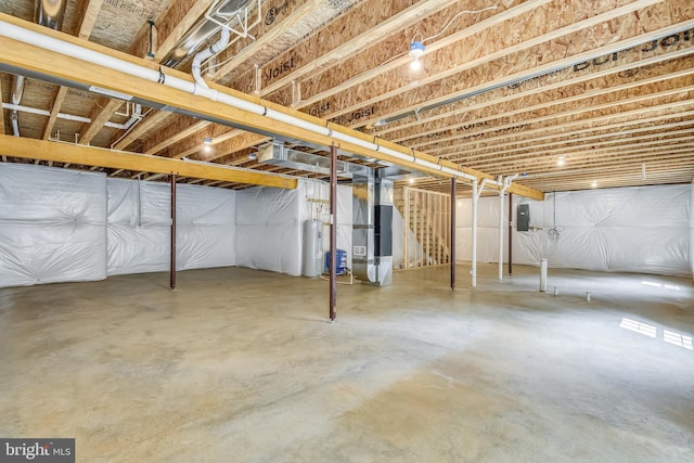 basement with electric panel, electric water heater, and heating unit