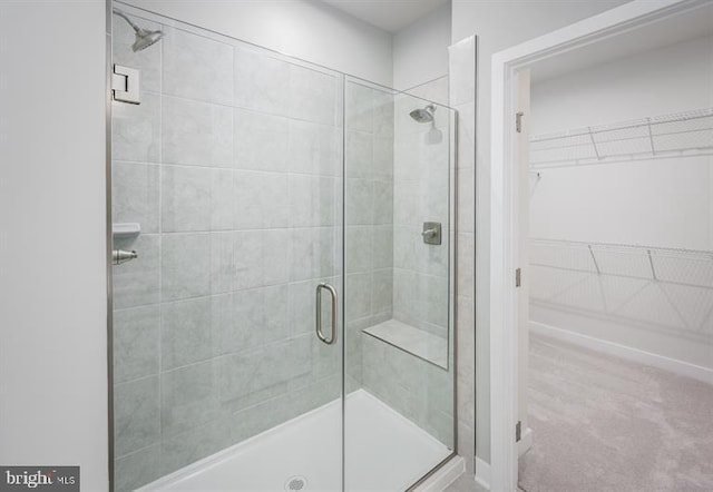 bathroom featuring a shower with shower door