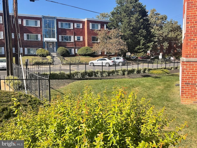 view of home's community featuring a lawn