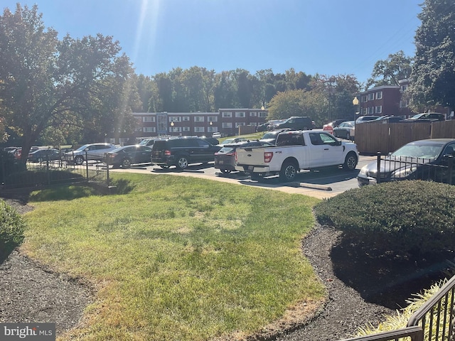 view of car parking featuring a lawn