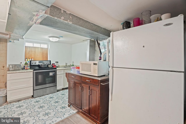 kitchen with light hardwood / wood-style floors, white cabinets, sink, and white appliances