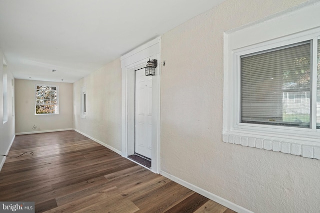 hallway with dark hardwood / wood-style flooring