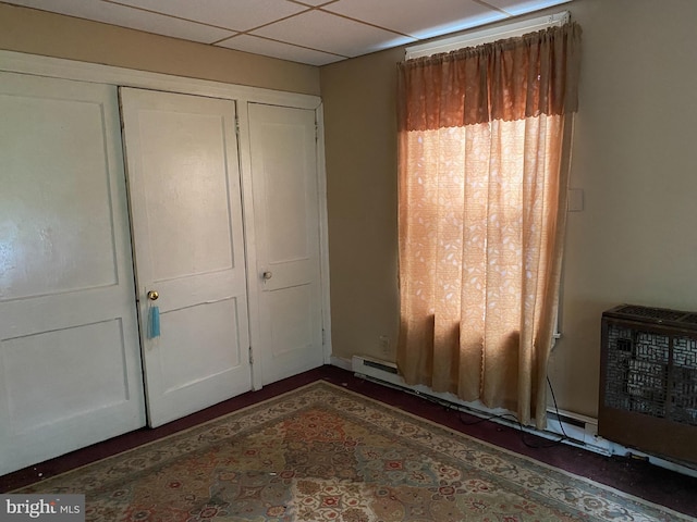 interior space with a paneled ceiling and a closet