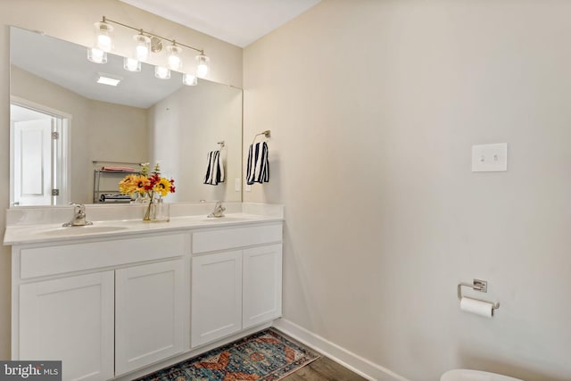 bathroom with vanity and hardwood / wood-style floors