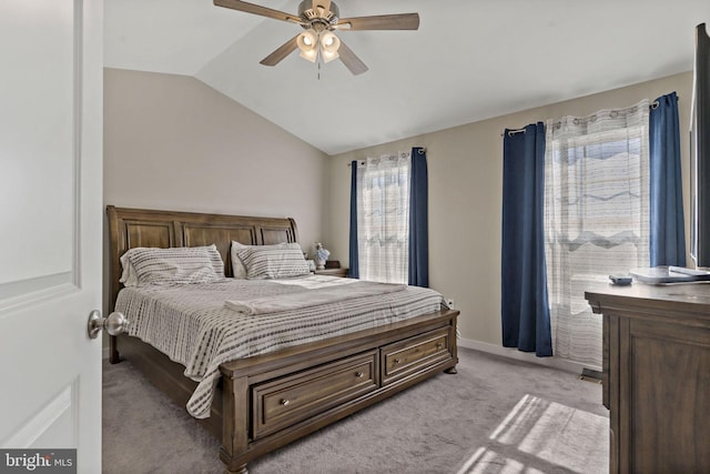 bedroom with ceiling fan, lofted ceiling, and light colored carpet