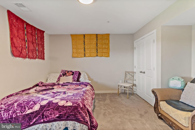 carpeted bedroom featuring a closet