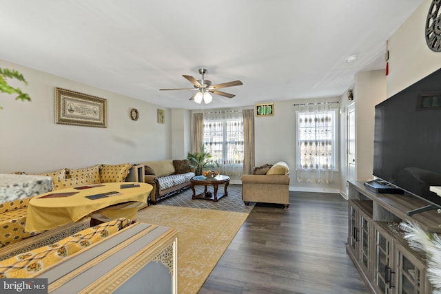 living room with dark wood-type flooring and ceiling fan