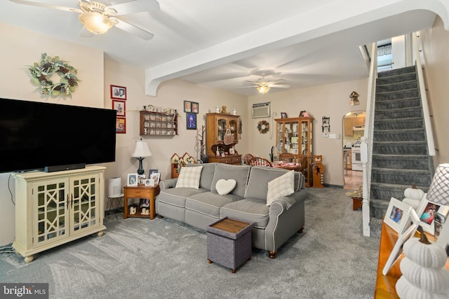 living room with ceiling fan, carpet flooring, beam ceiling, and a wall mounted AC