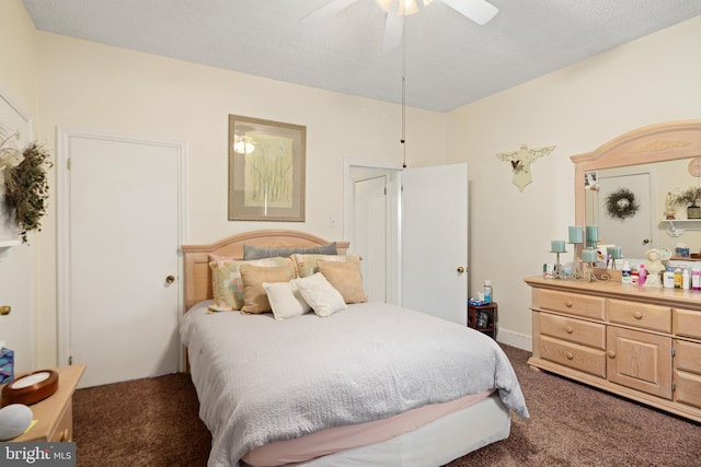 carpeted bedroom featuring a textured ceiling and ceiling fan