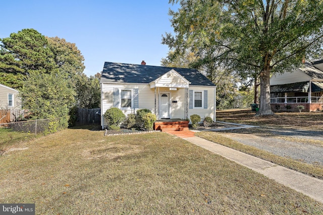 bungalow-style house with a front lawn