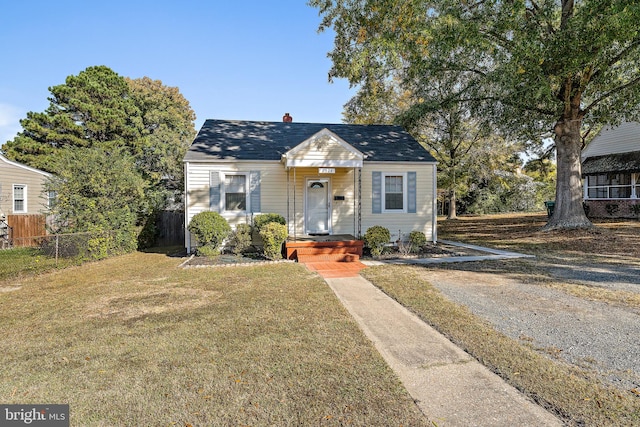 bungalow-style house with a front lawn