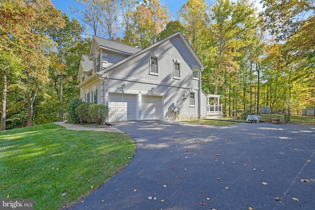 view of property exterior featuring a yard and a garage