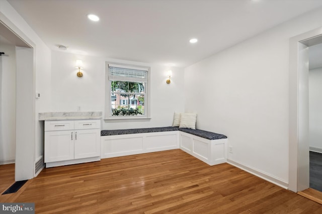 interior space with white cabinets and light hardwood / wood-style floors