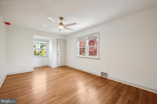 empty room with light hardwood / wood-style floors and ceiling fan