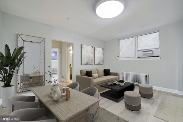 living room featuring radiator, cooling unit, and light wood-type flooring