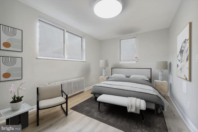 bedroom featuring radiator and light wood-type flooring