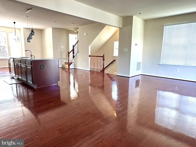 unfurnished room with dark hardwood / wood-style floors and sink