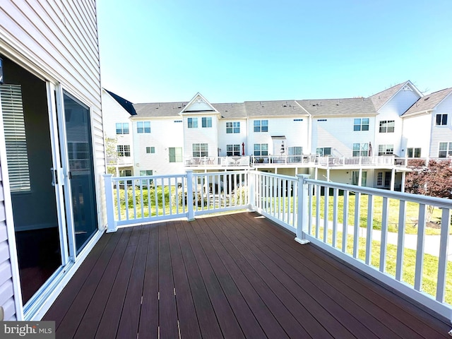 wooden deck with a lawn