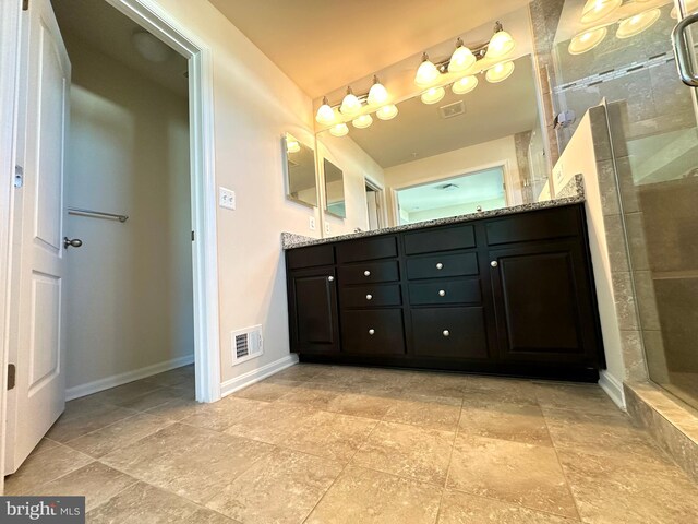 bathroom featuring vanity and a shower with shower door