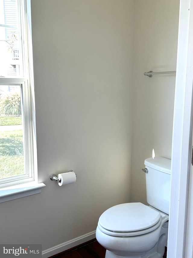 bathroom featuring toilet, a healthy amount of sunlight, and hardwood / wood-style flooring